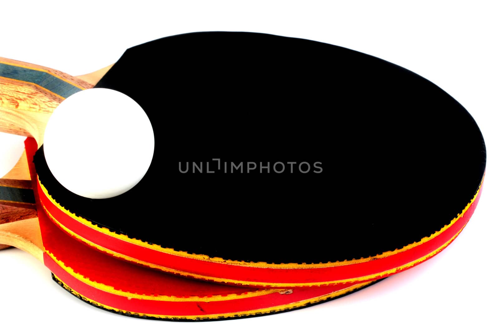 Two ping pong paddles with ball isolated on white.