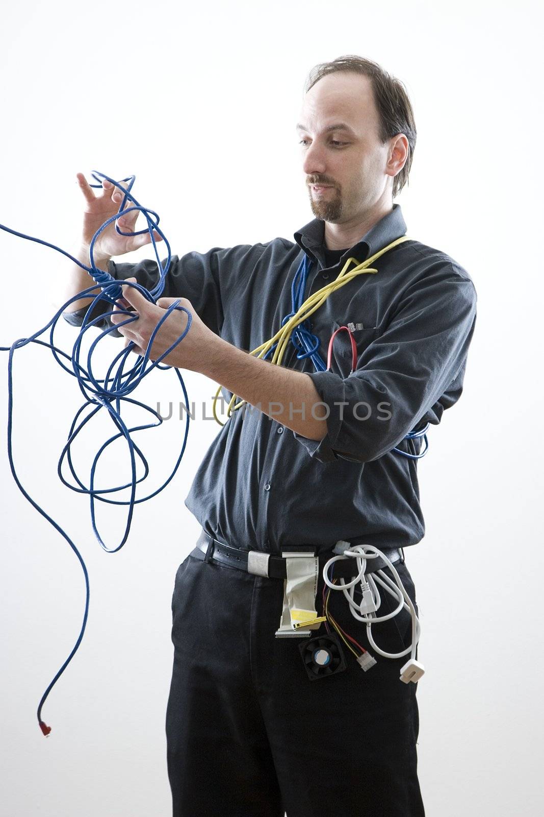 Computer technician looking confuse trying to untie network cable