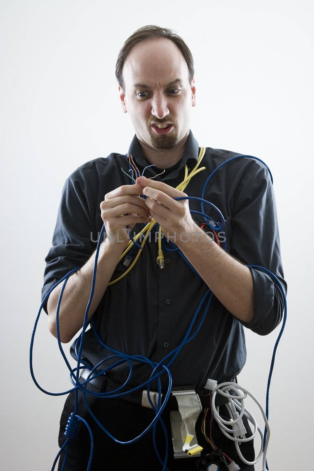 Dumb technician lost by wires in his hand