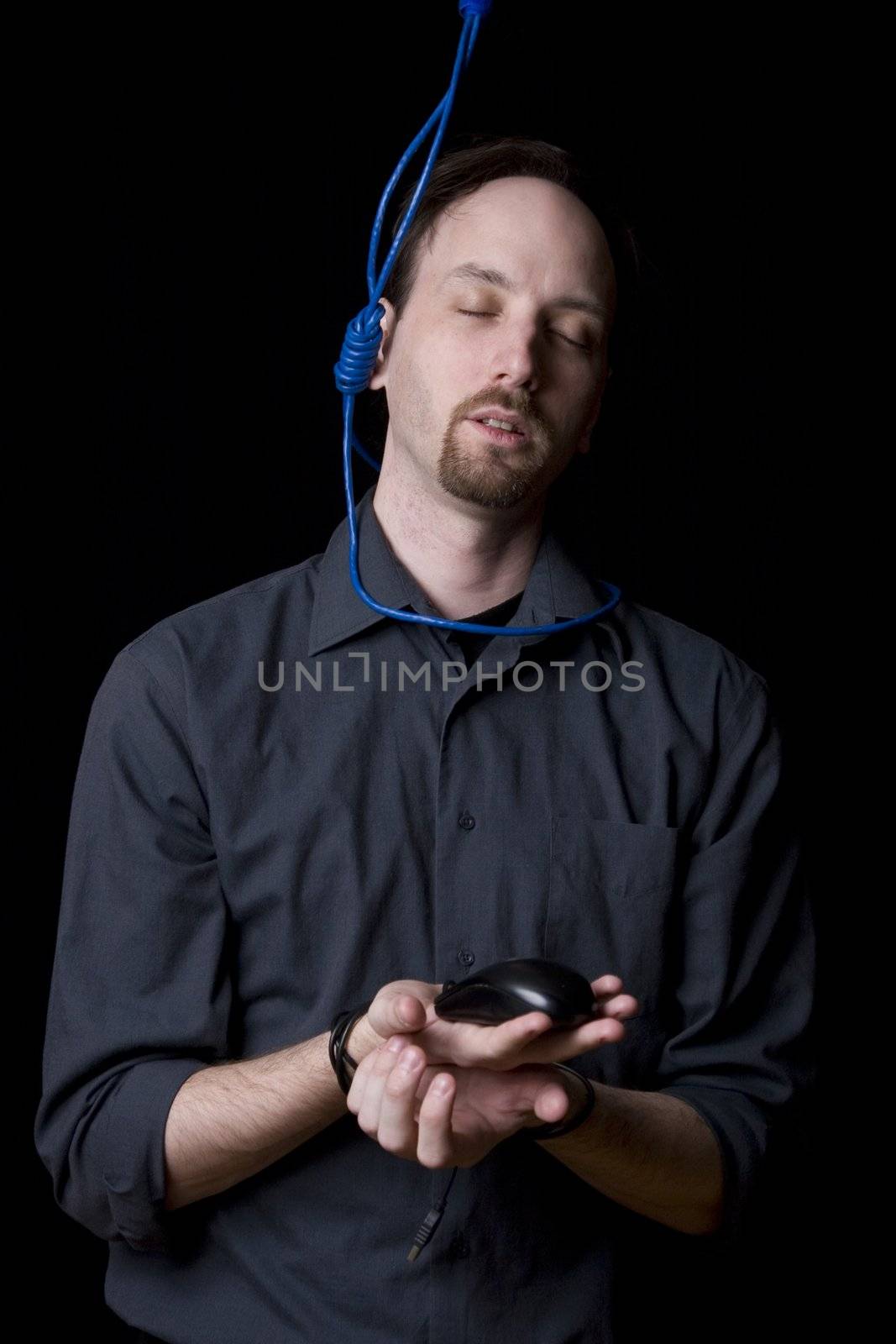 Computer technician with tied hands and hangman noeuce around his neck, accepting his faith and closing his eyes