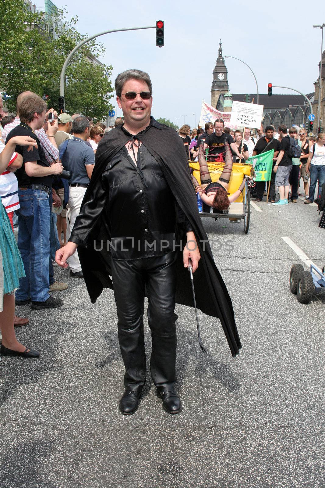 Gay street parade Christopher Street Day (CSD) in Hamburg, 8th August 2009. Sadist with whip (crop).