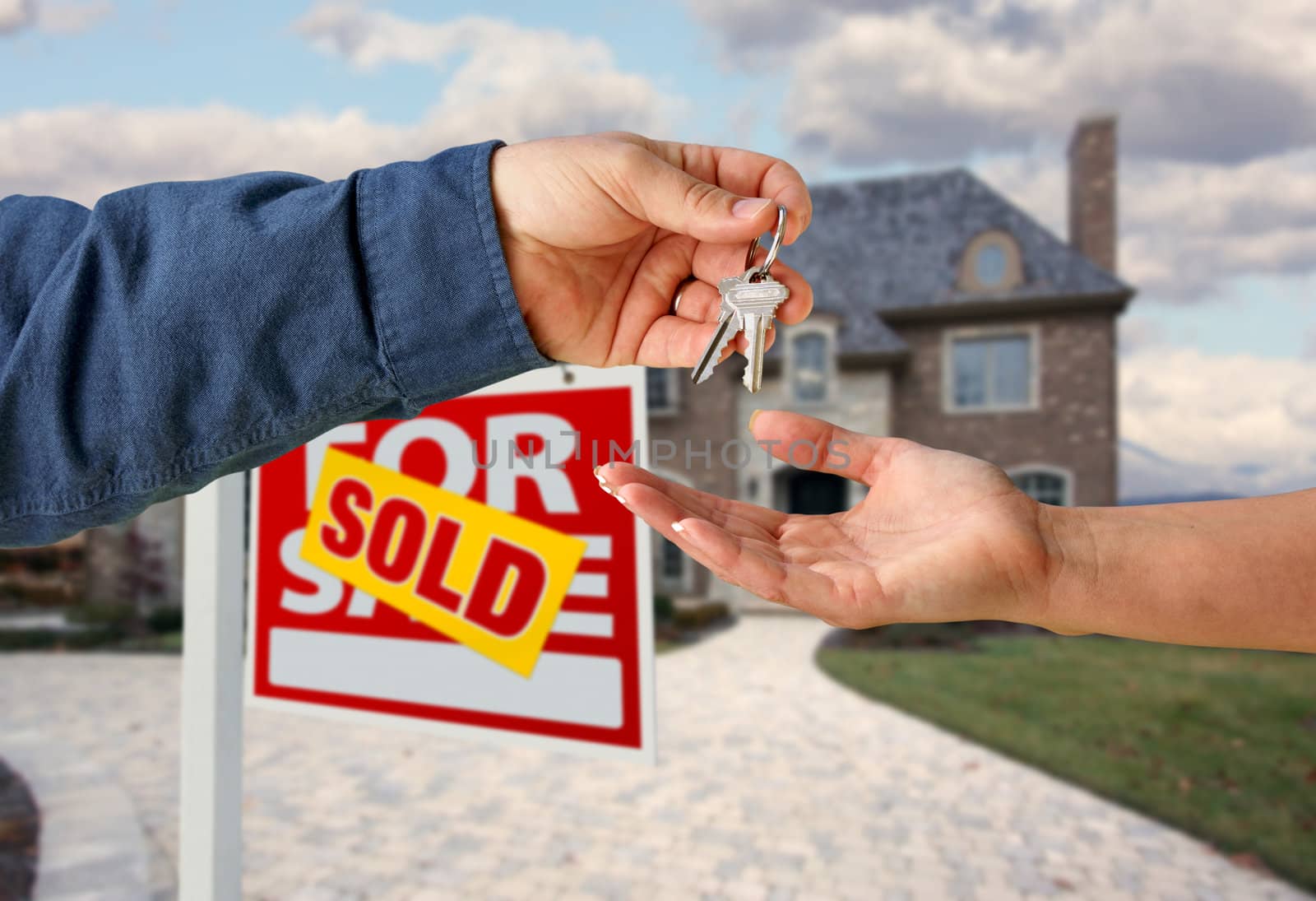 Handing Over the House Keys in Front of a Beautiful New Home.