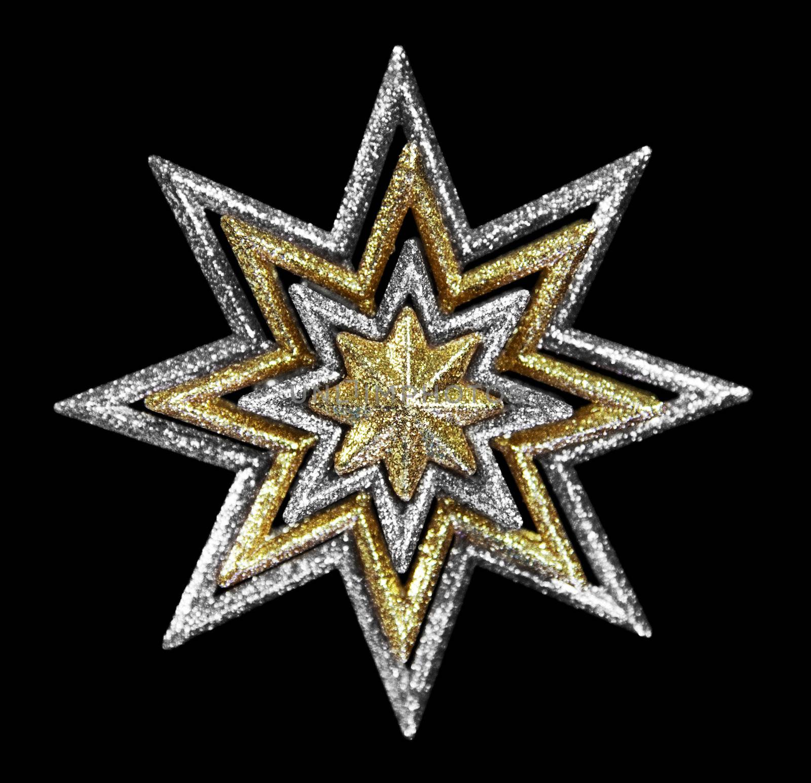 A gold and silver Christmas star against black