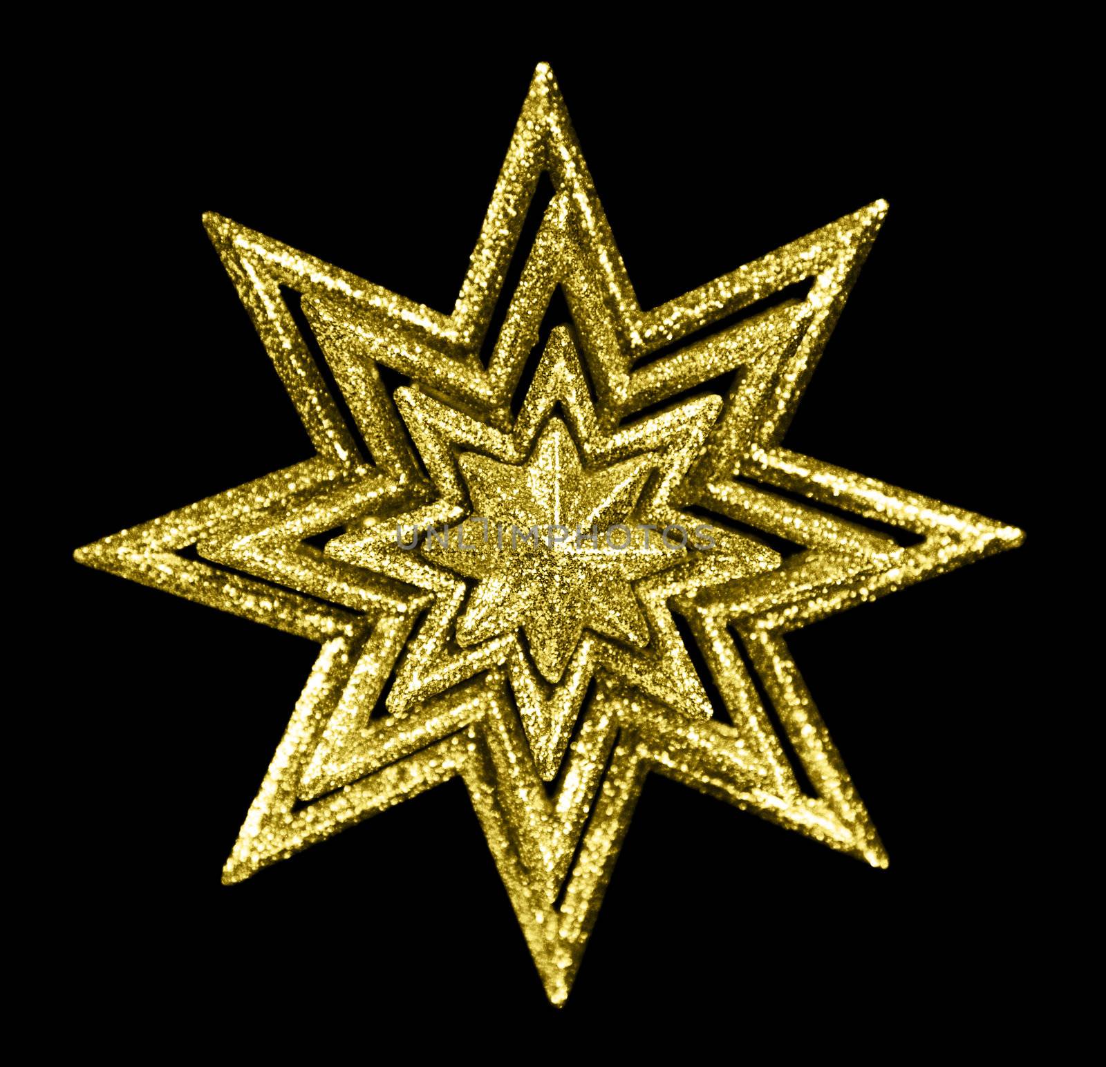 A gold Christmas star against black