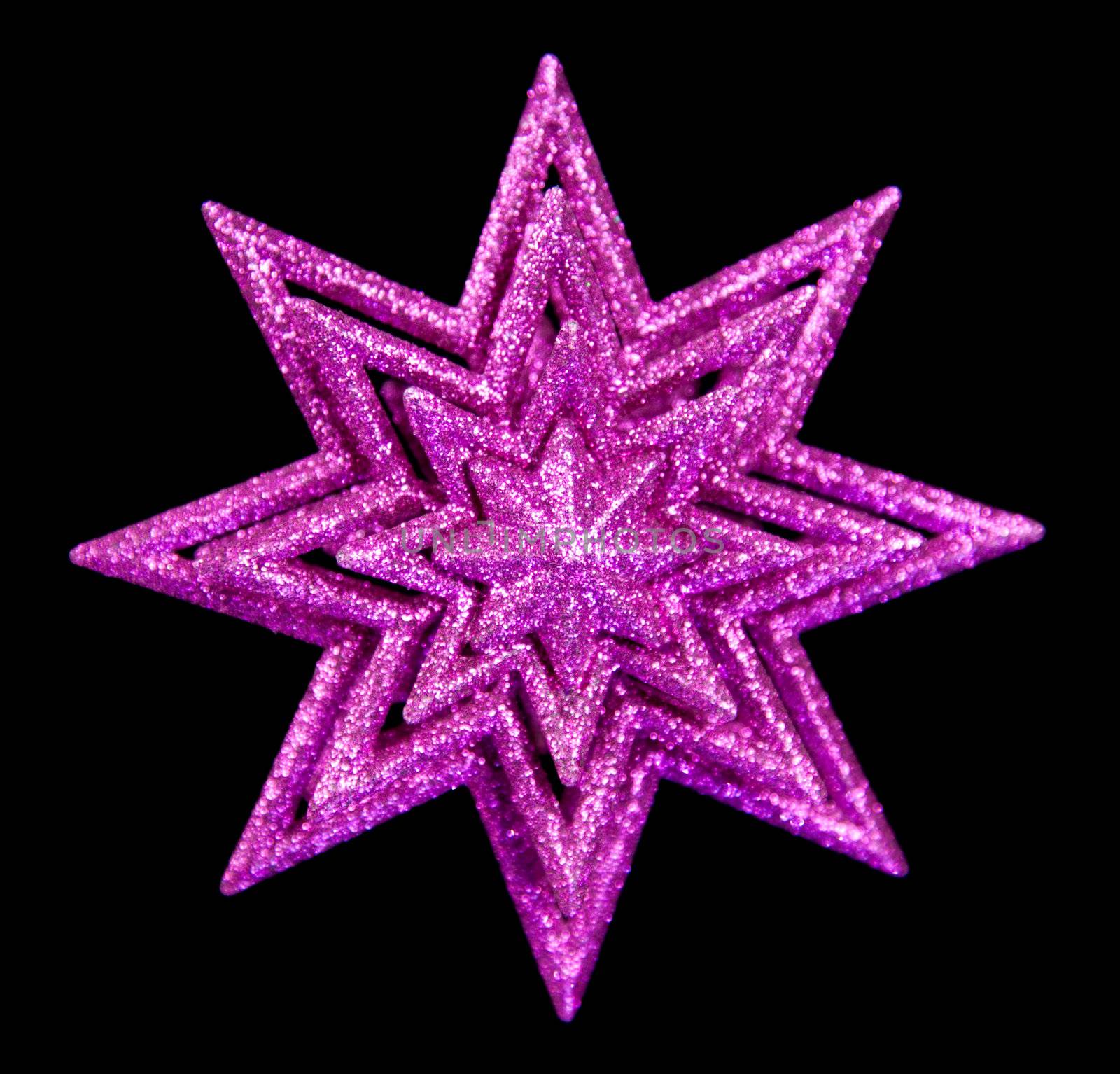 Purple Christmas Star against black by monkeystock
