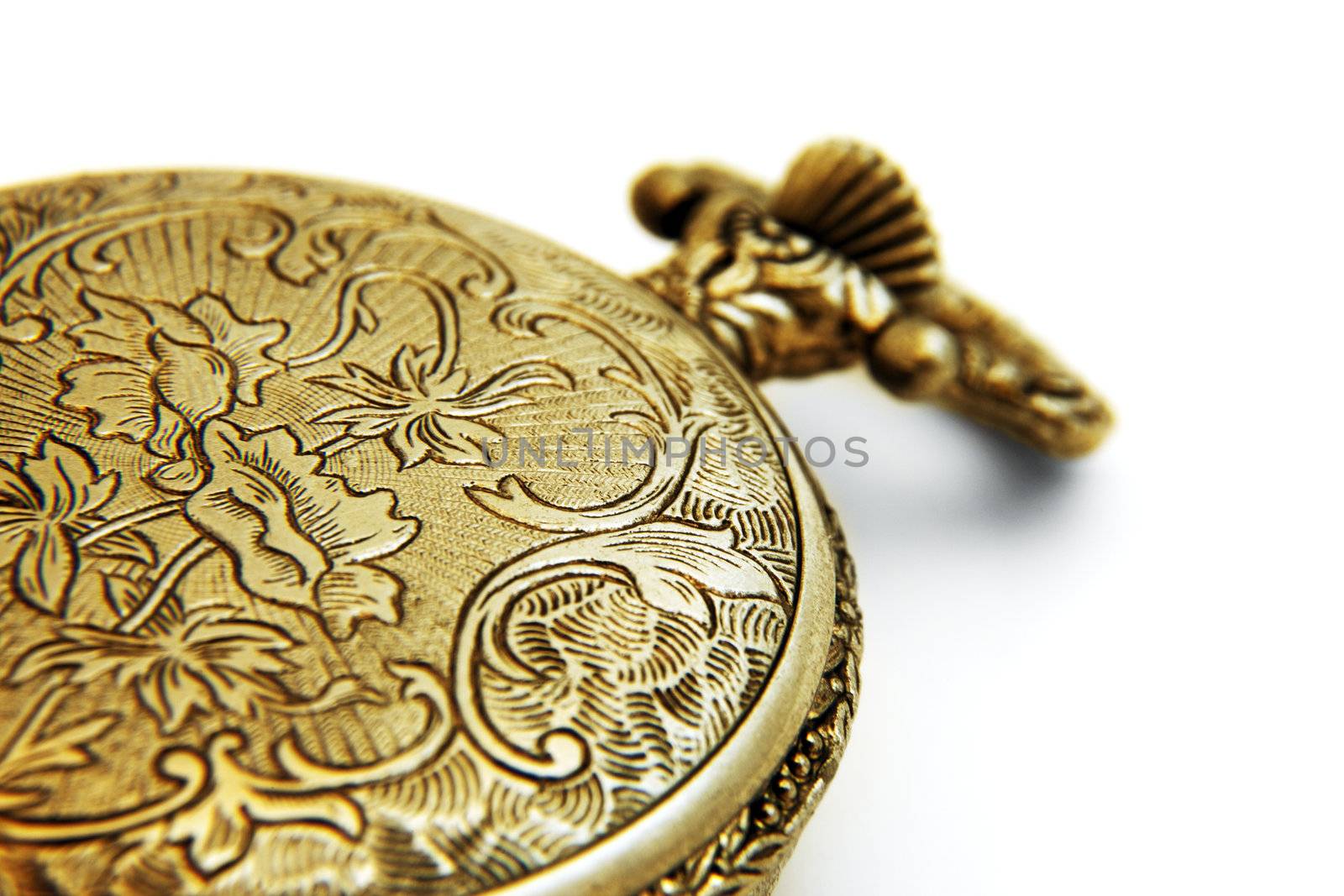 Macro shot of a closed gold pocket watch against white