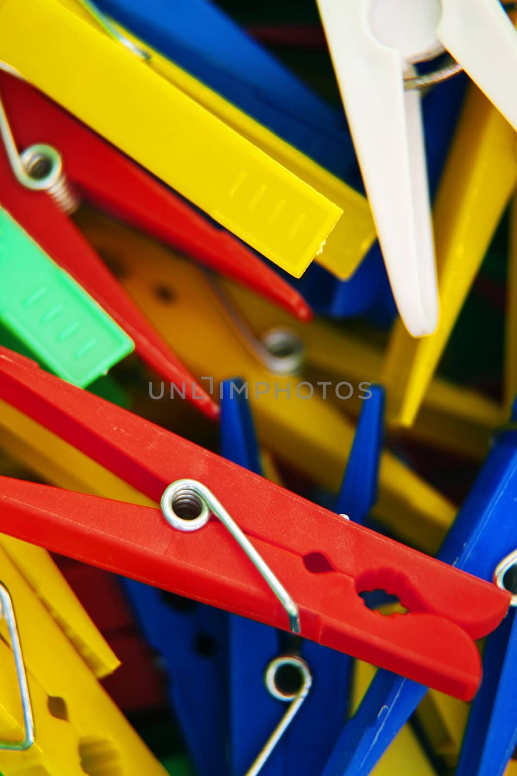 macro of colourful plastic pegs