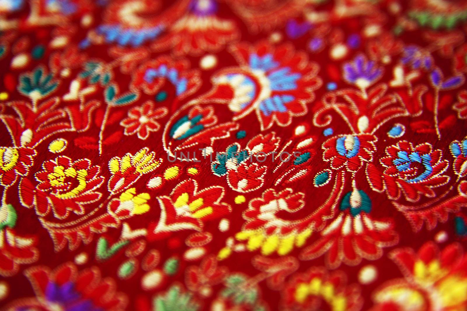 Macro of a woven red paisley fabric