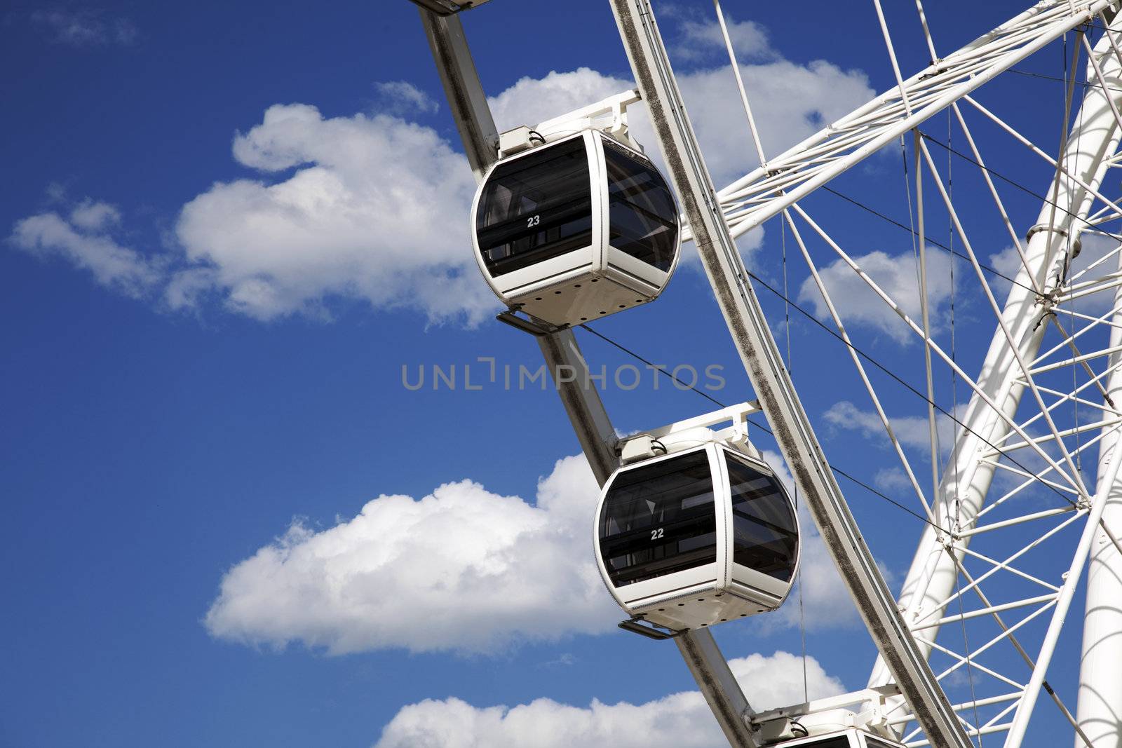 A couple of ferris wheel cars against a beautiful blue sky
