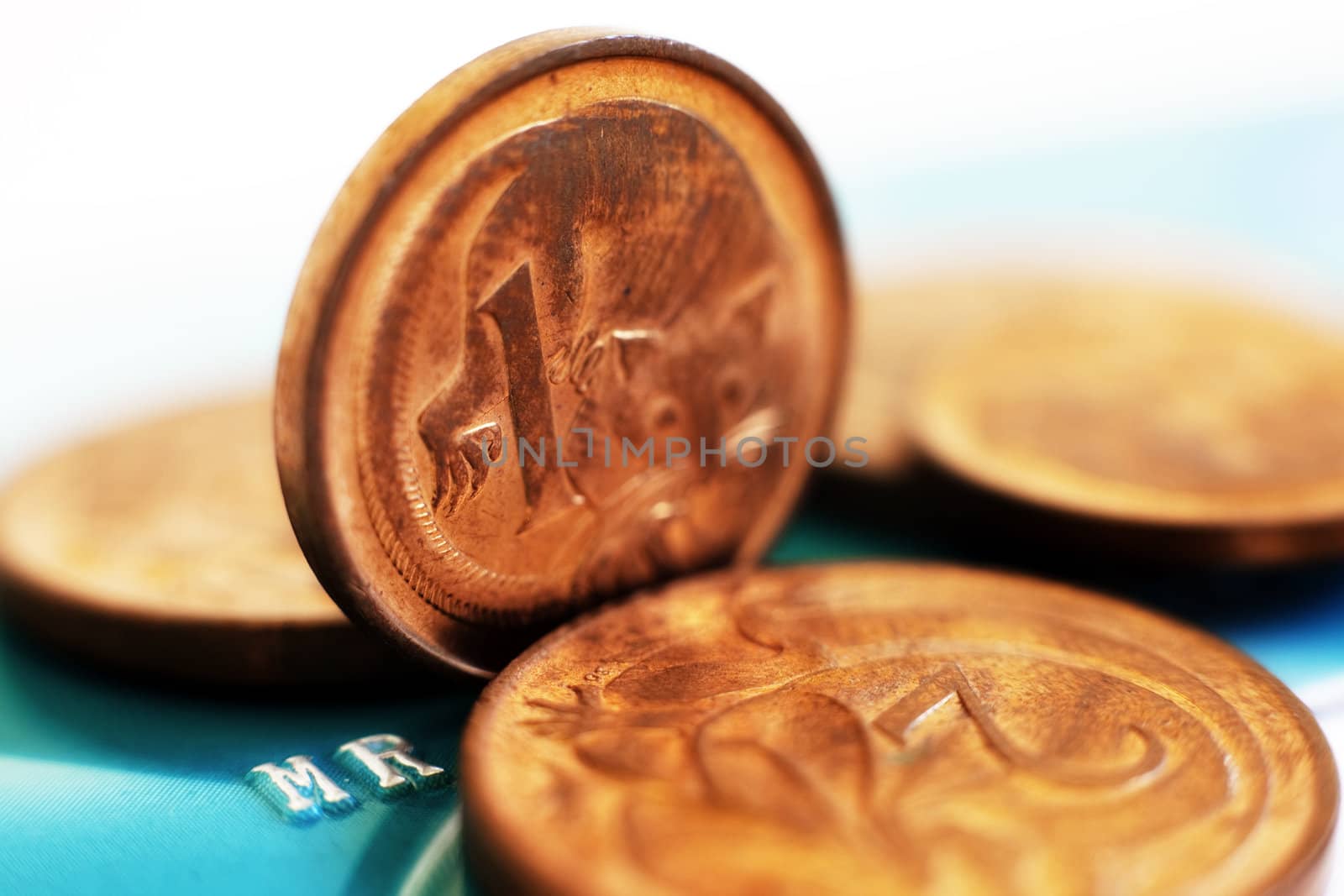 One cent coin standing on a credit card