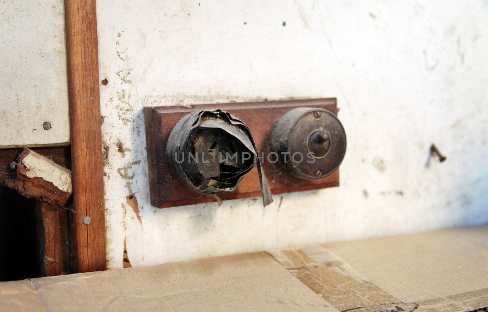 Close up of an old broken electrical socket, shoddily covered up