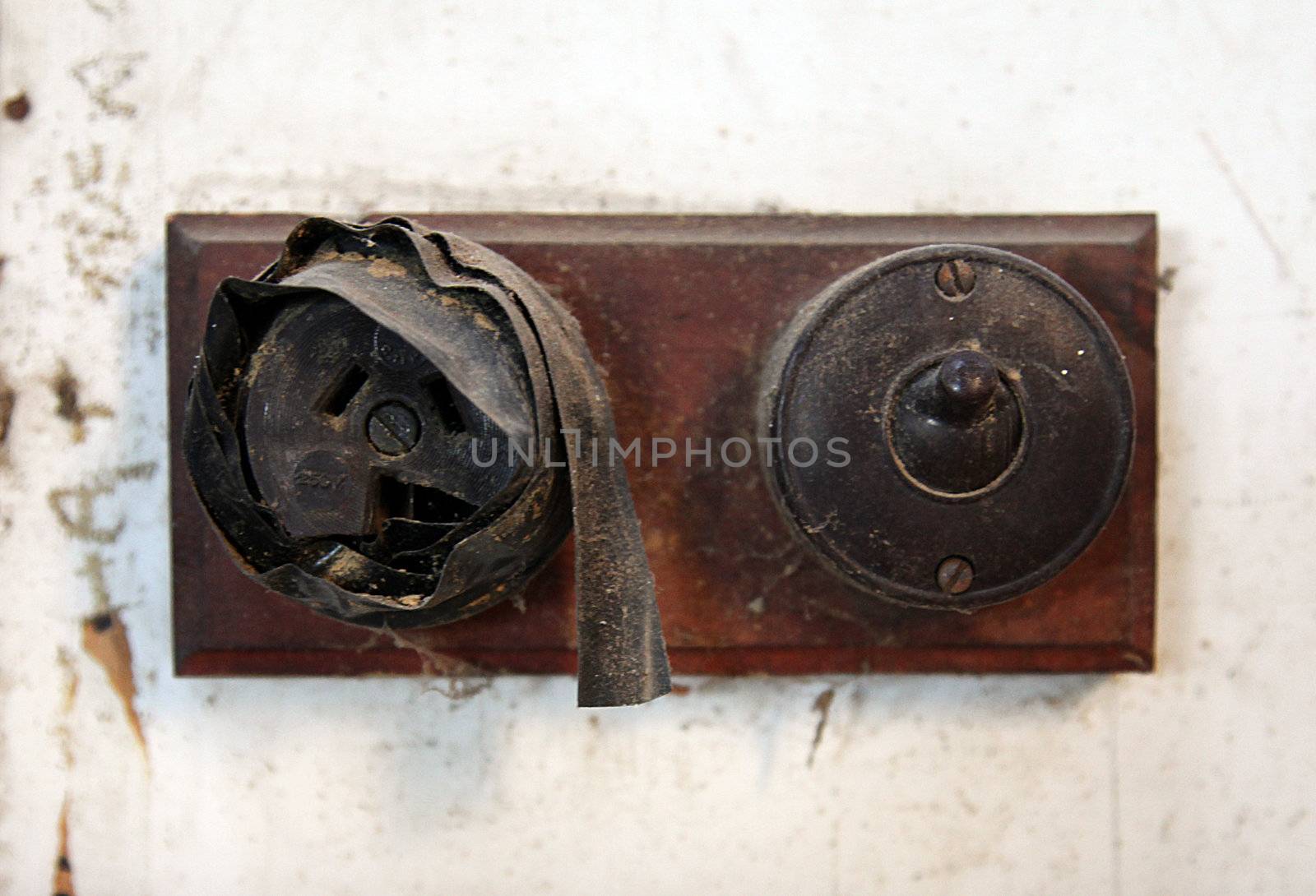 Close up of an old broken electrical socket, shoddily covered up