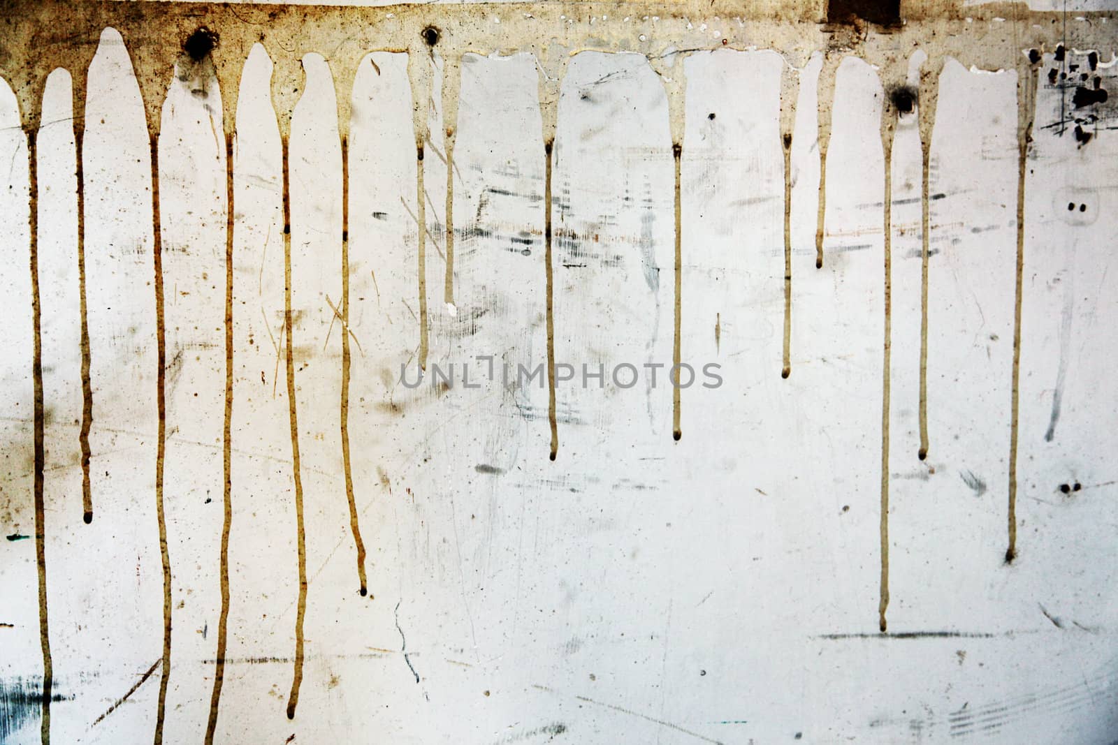 Messy substance dripping down a grungy wall