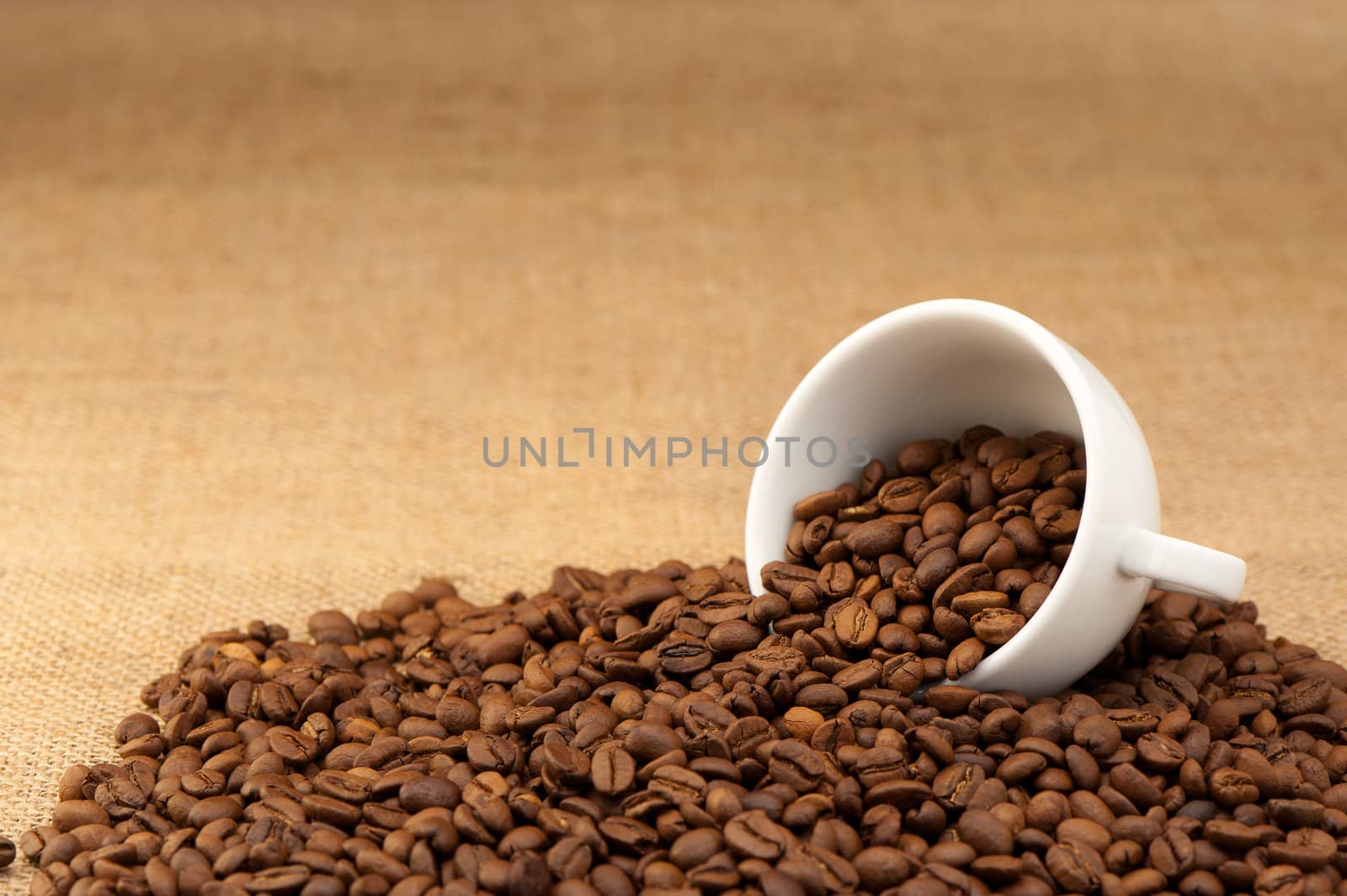 White cup with coffee grains. Grunge background