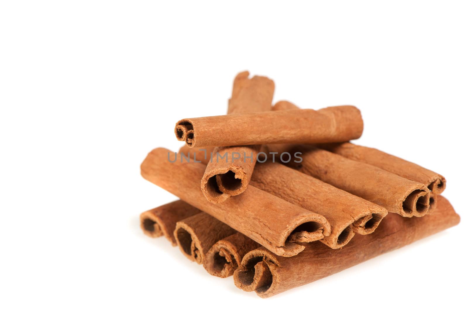 Cinnamon. A heap of sticks of cinnamon on a white background