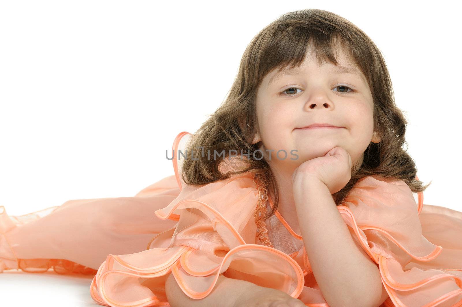 Pretty the little girl lies on the white. It is isolated on a white background