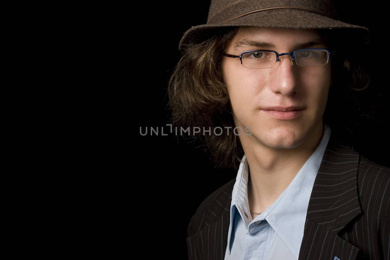 Male teenager wearing a hat and glass