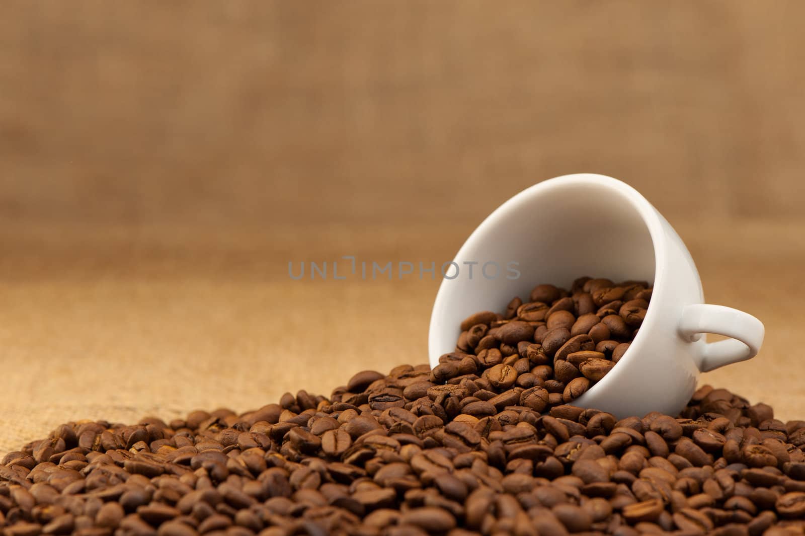 White cup with coffee grains. Grunge background