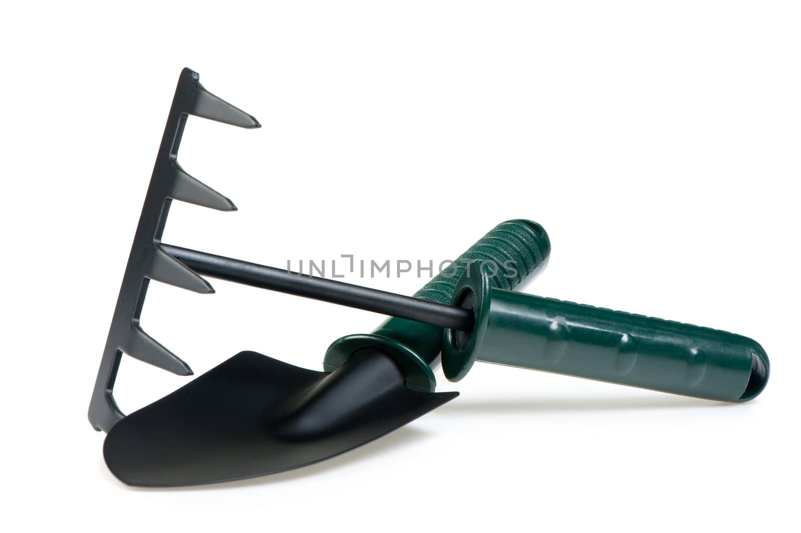 The garden tool a shovel, a rake. Isolated on a white background