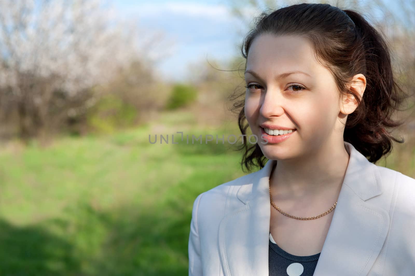 Portrait of the attractive woman. Against the spring nature