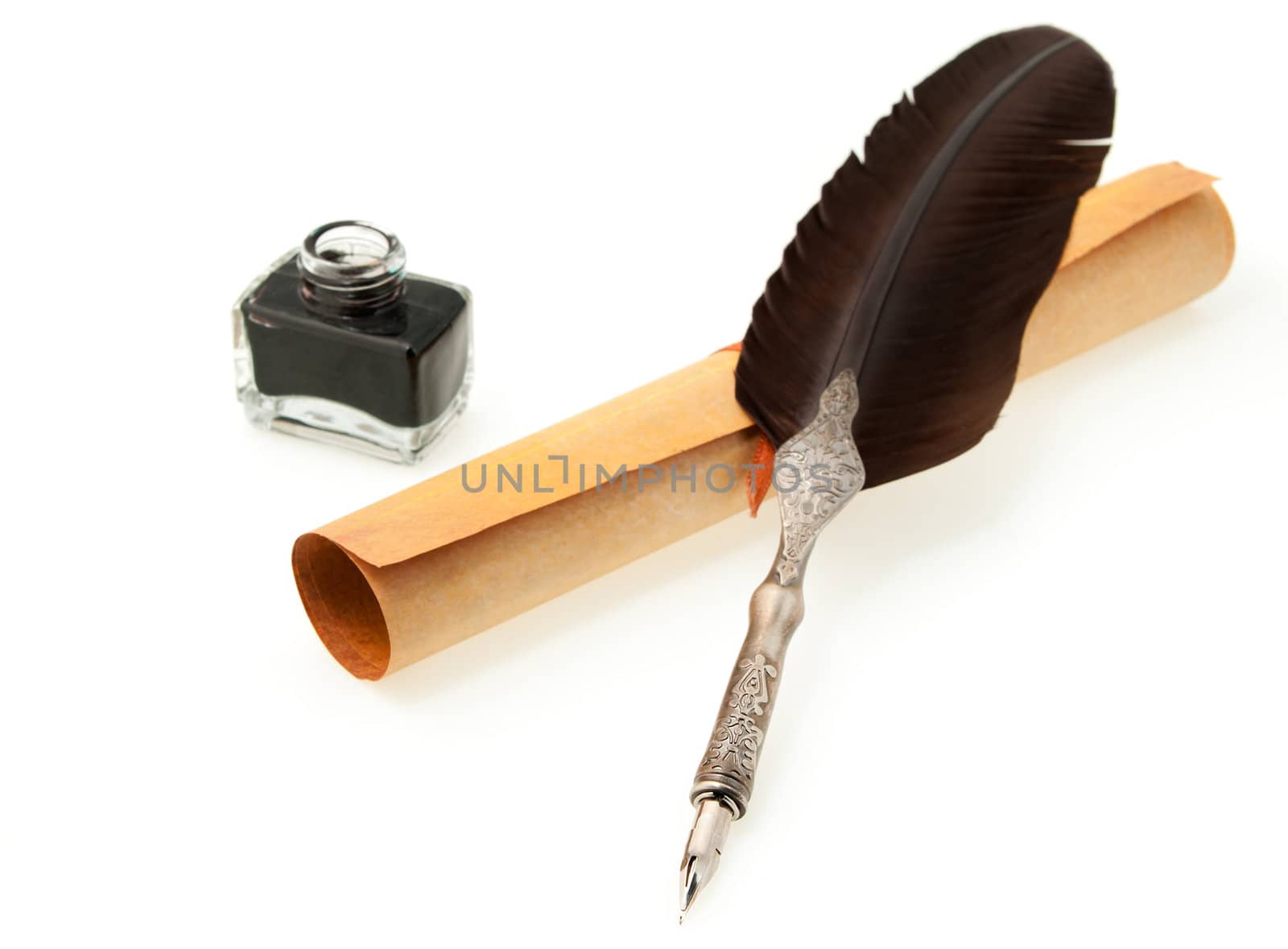 Feather quill ,inkwell and parchment roll. Isolated on white