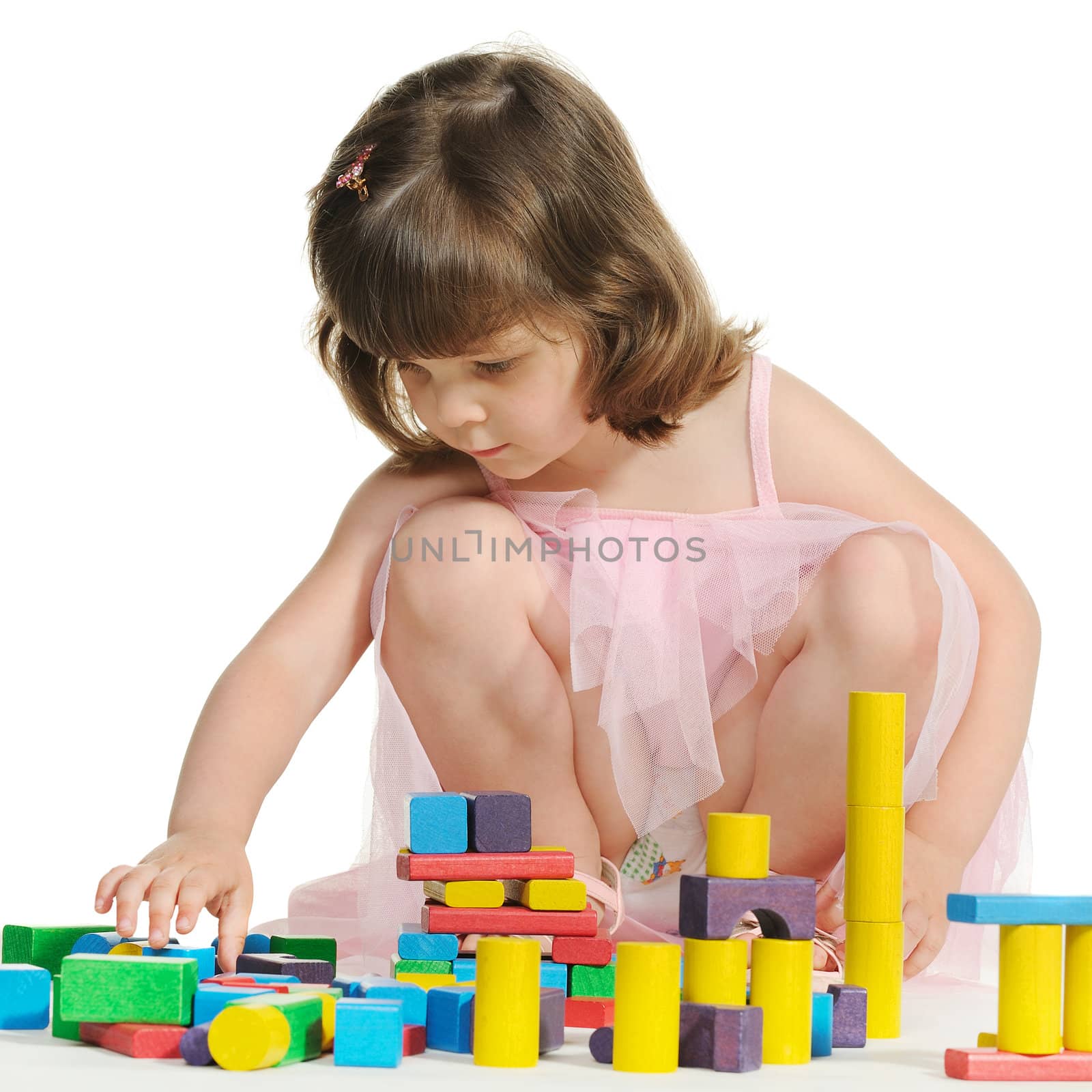 The lovely little girl plays colour wooden cubes by galdzer