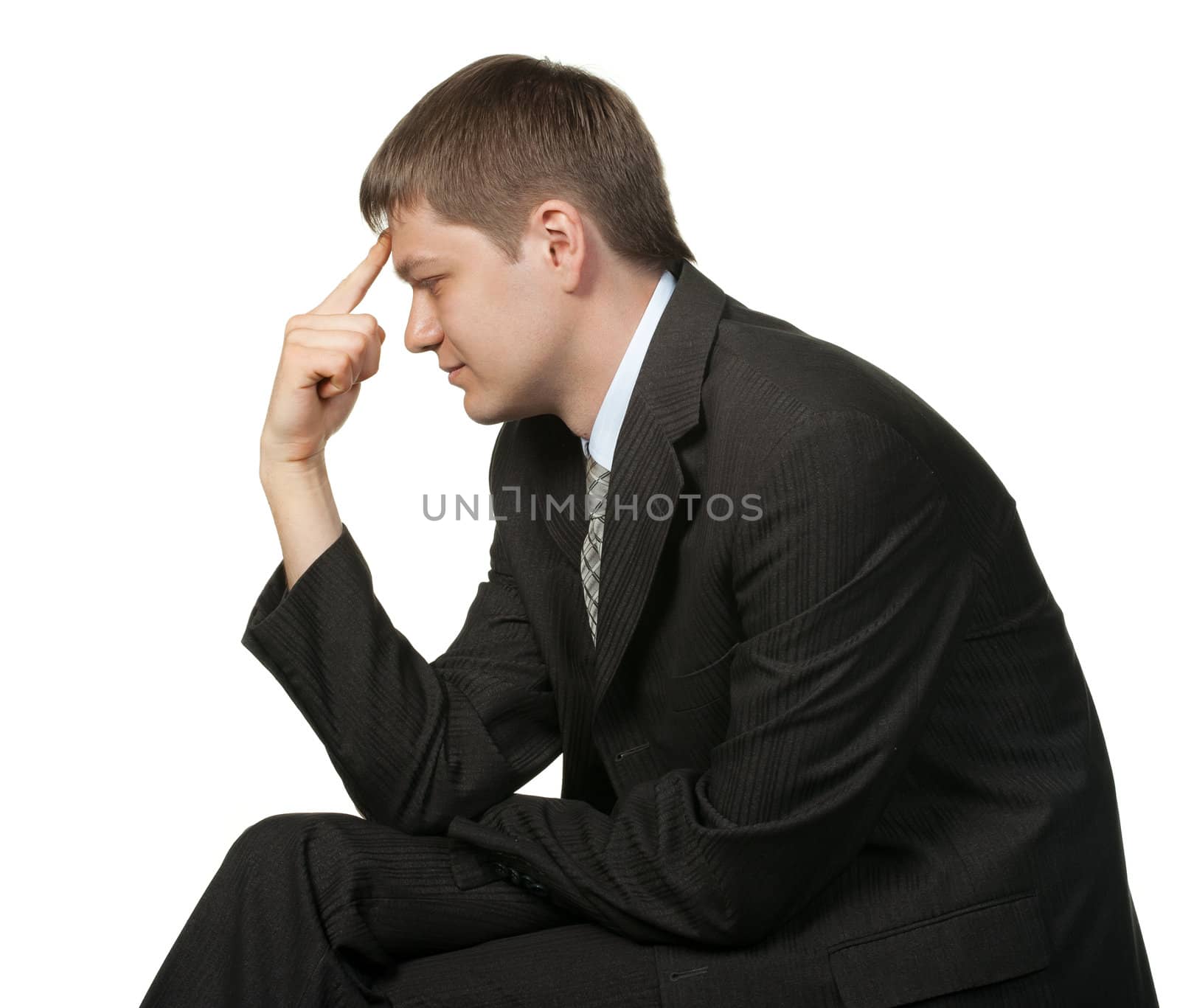 The thinking businessman.Finger at a forehead. It is isolated on a white background