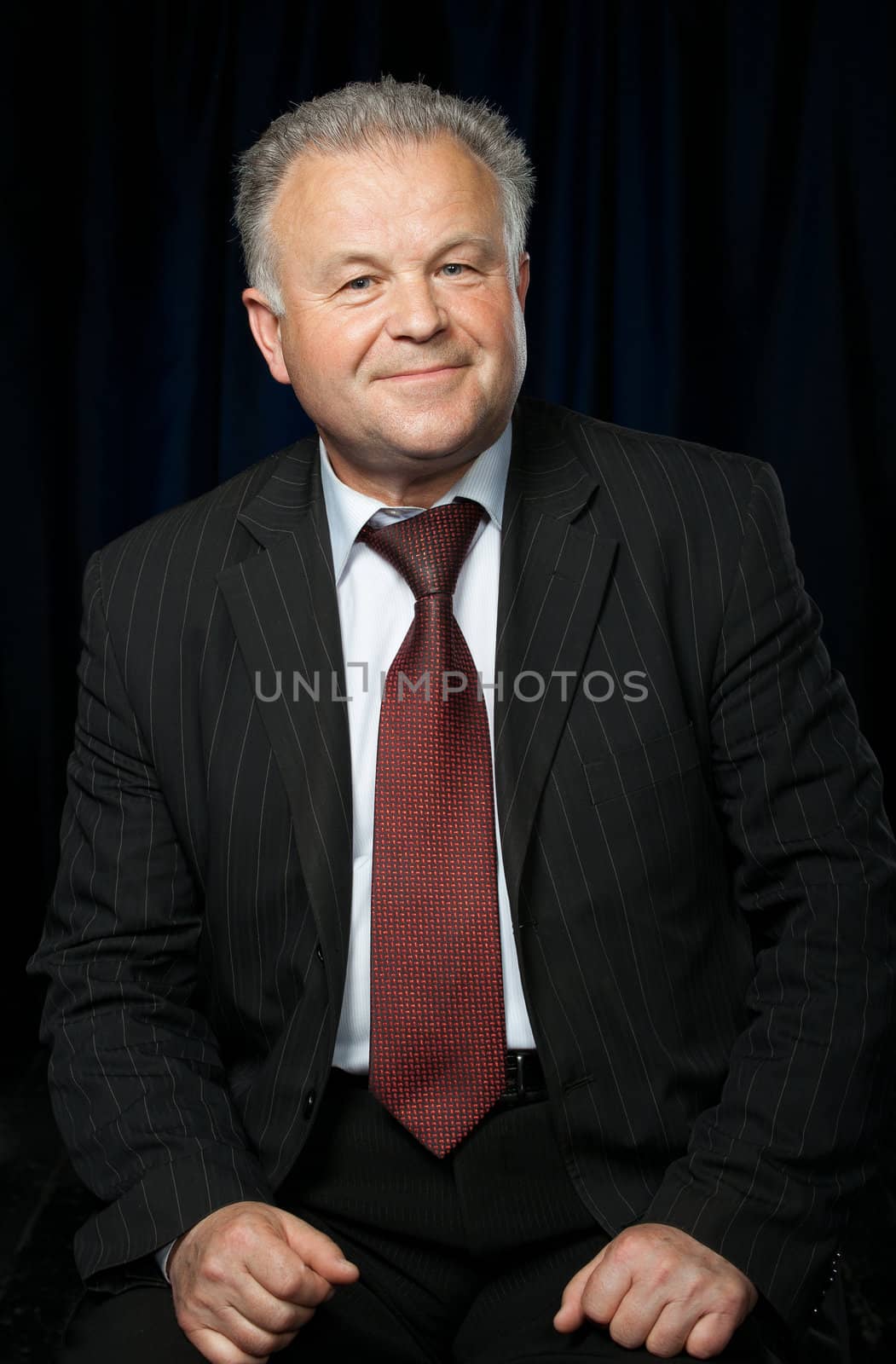 Portrait of the elderly man. A photo against a dark background