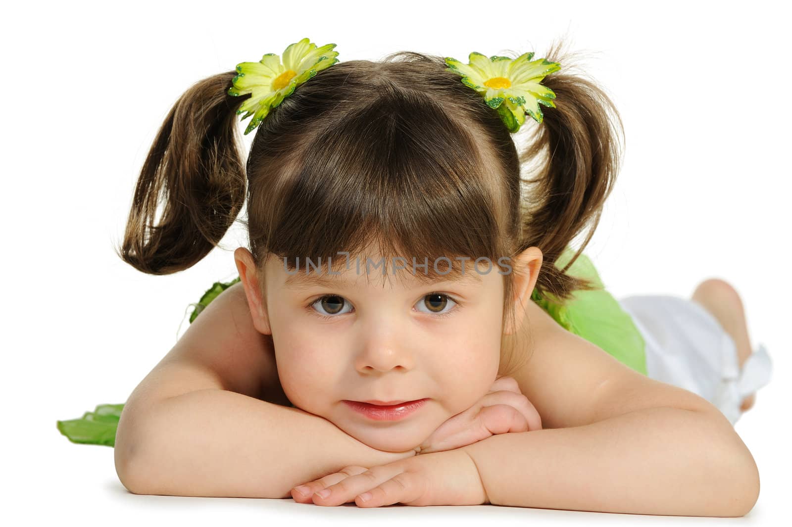 Pretty the little girl lies on the white. It is isolated on a white background