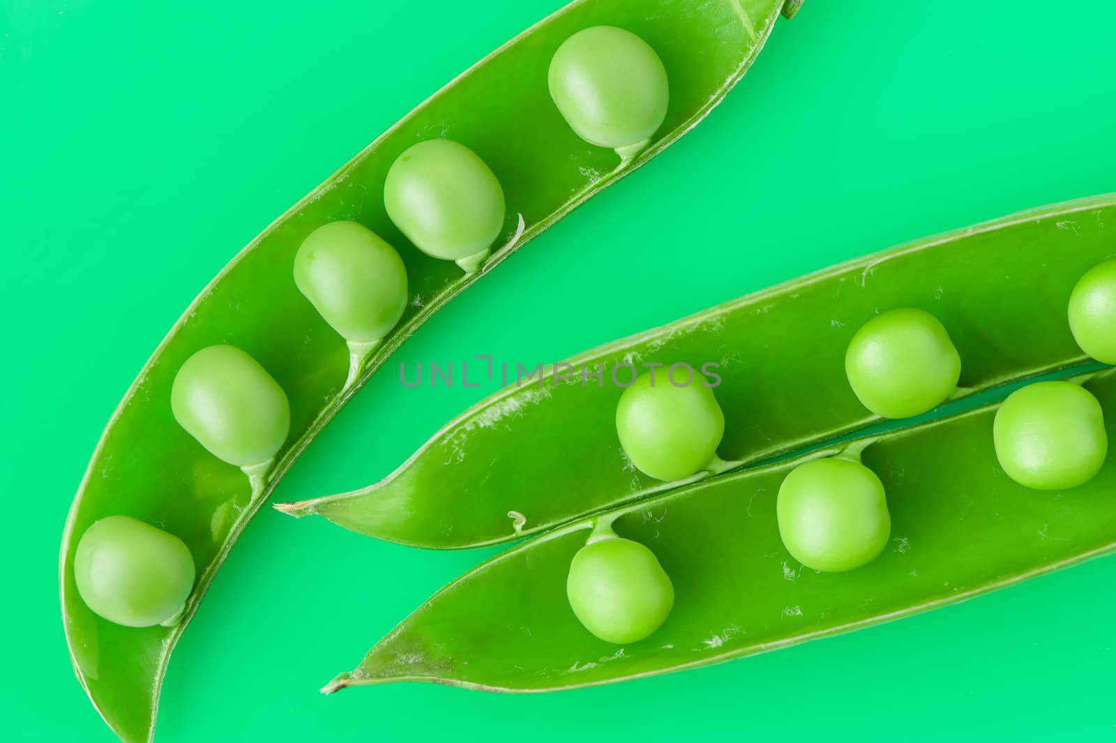 Pea. A photo by close up of green peas it is isolated on a green background