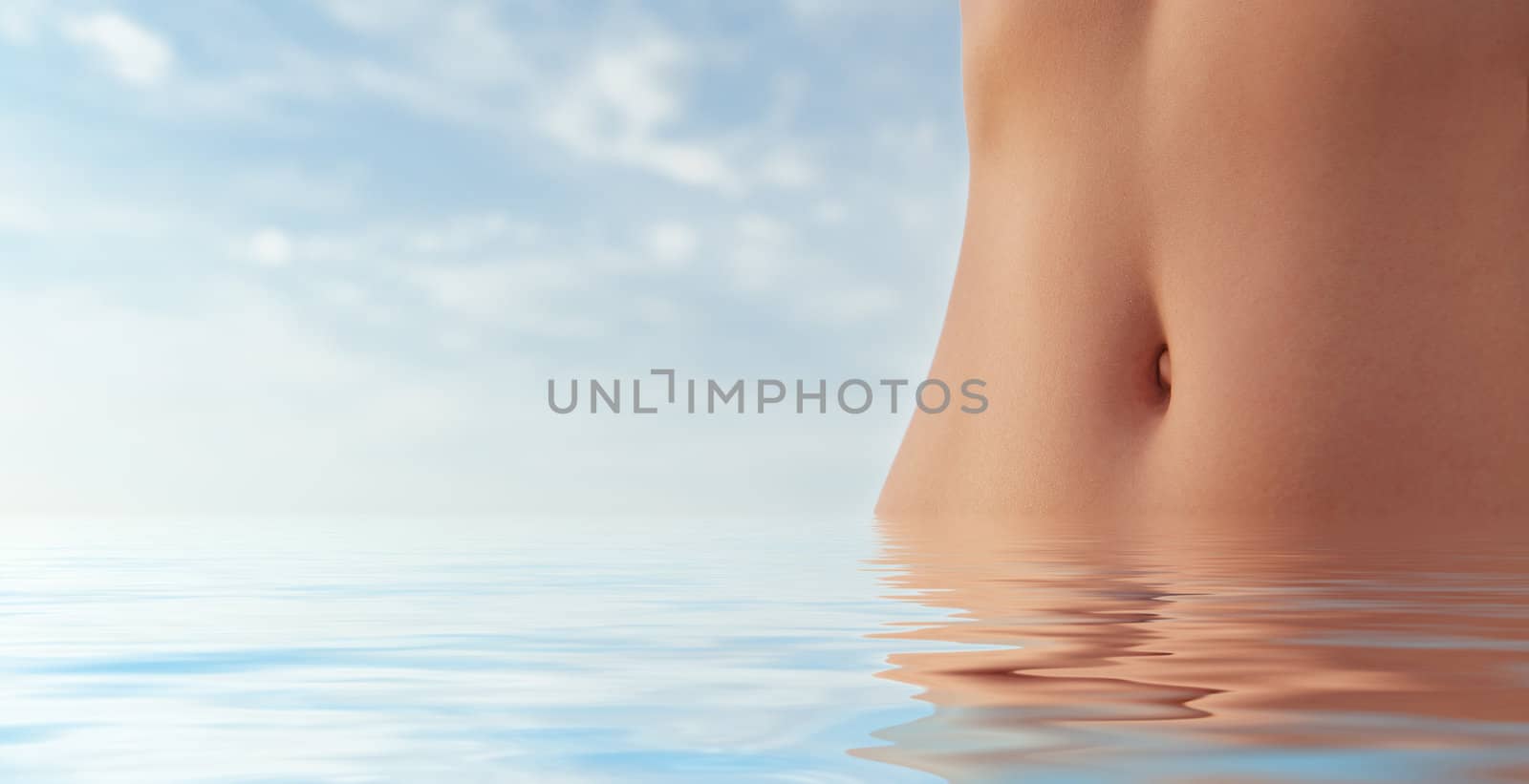 Beautiful female body in water. Blur sky background