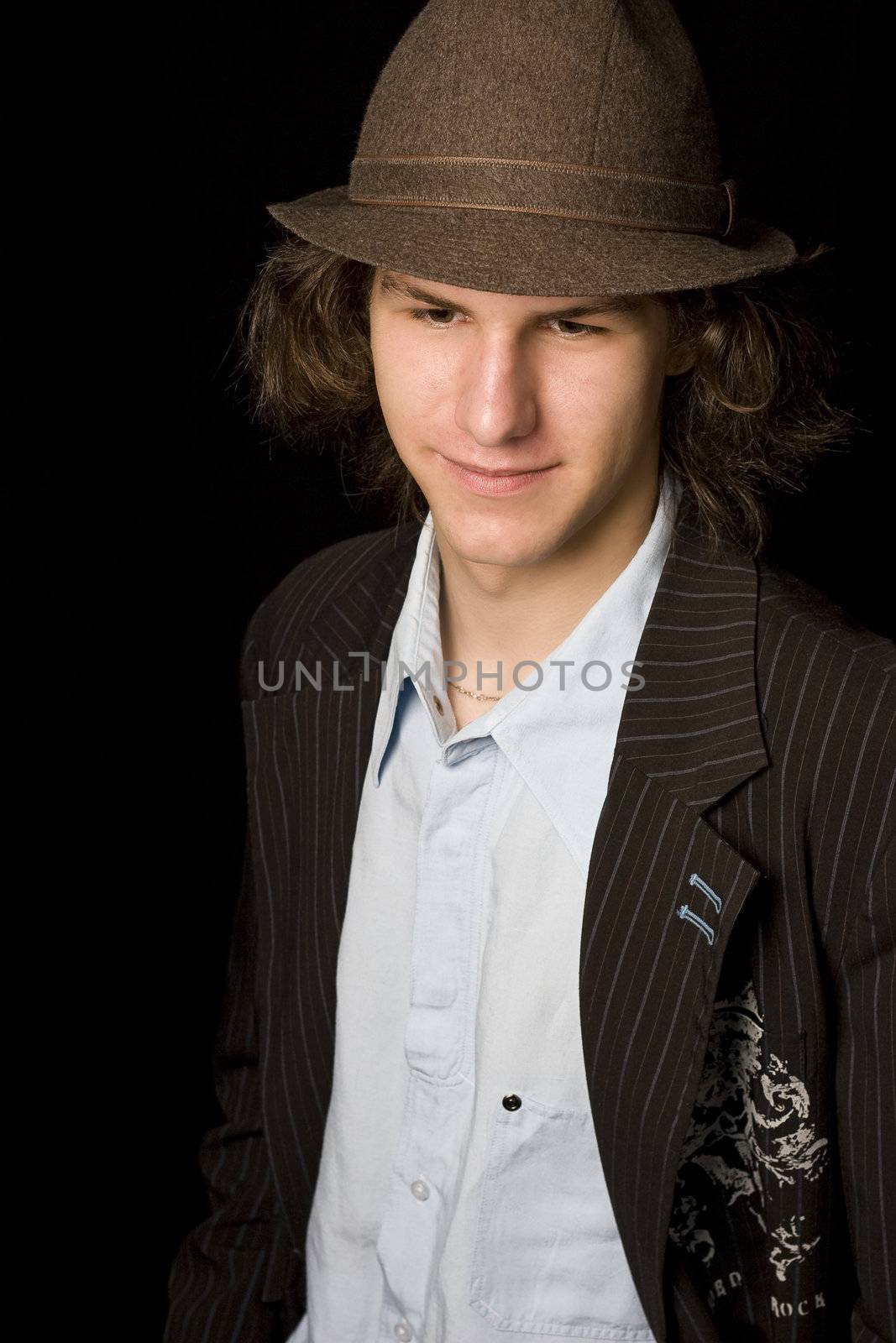 Male teenager wearing a suit and hat