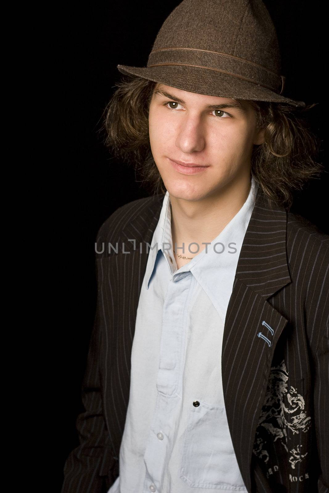 Male teenager wearing a suit and hat
