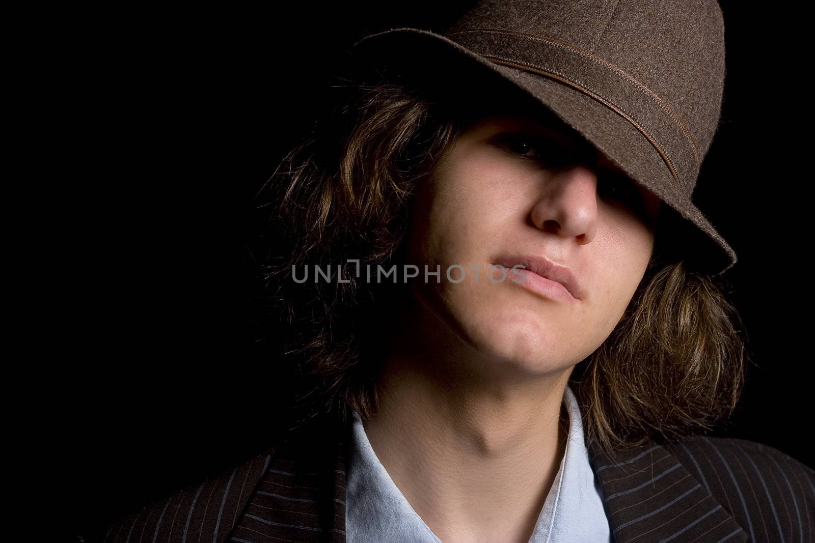 Male teenager with a hat tipped over the eyes