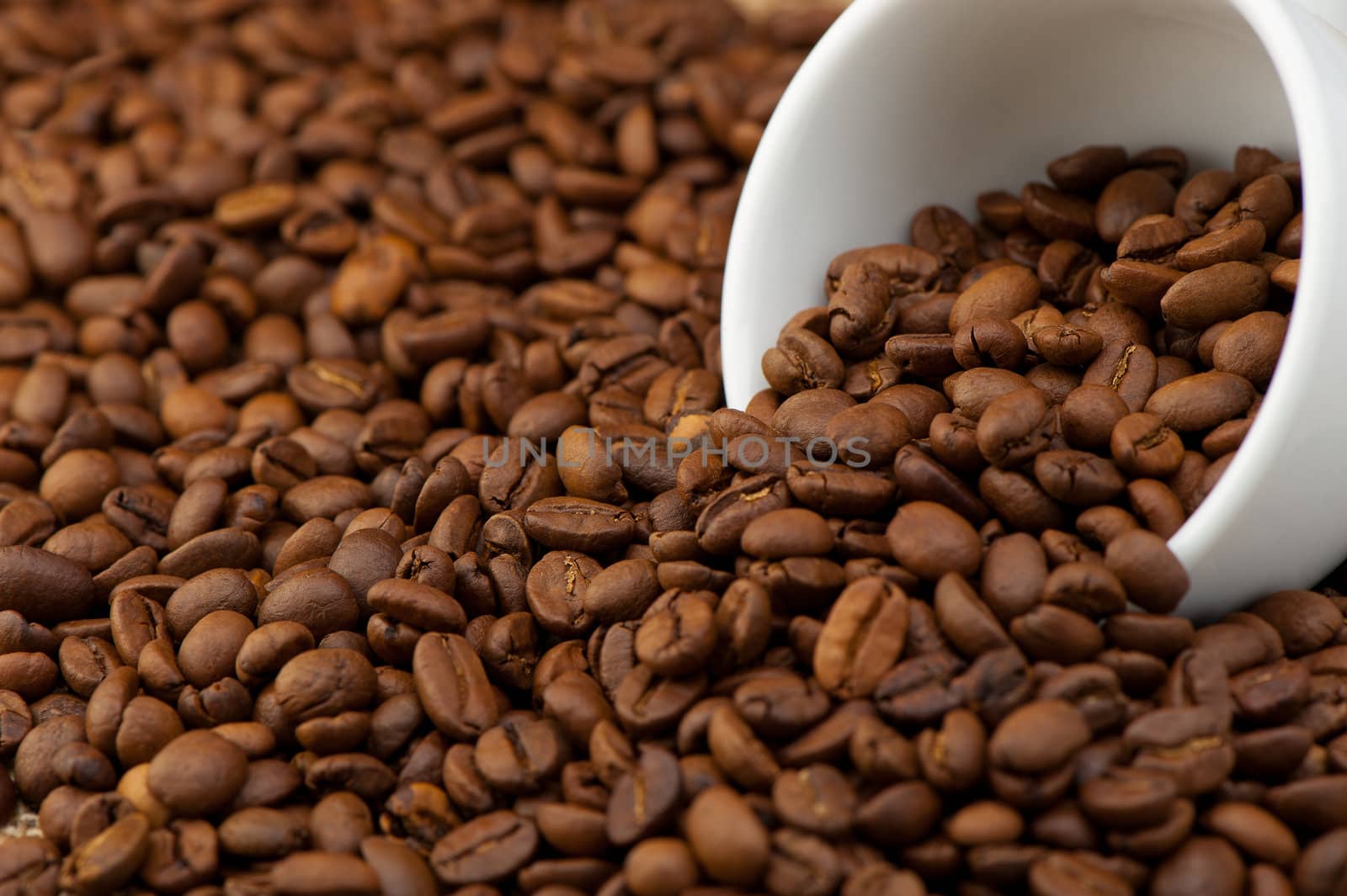 White cup with coffee grains. A photo close up