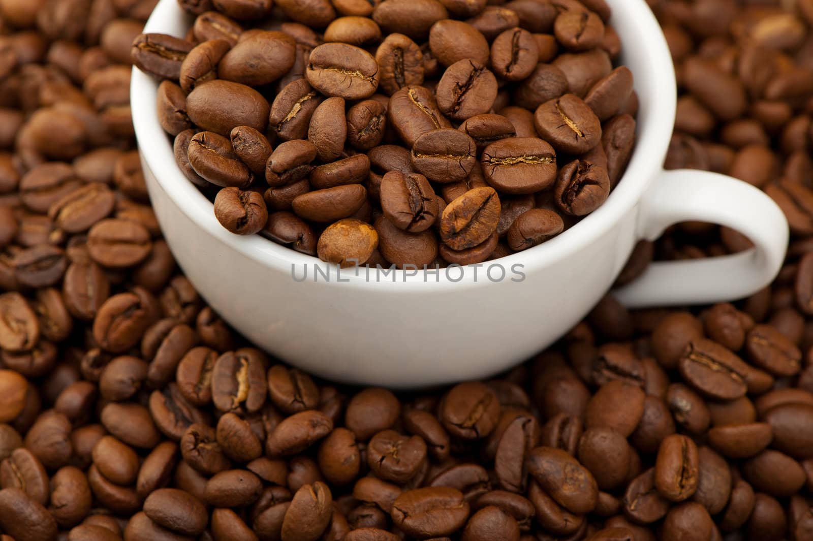 White cup with coffee grains. A photo close up