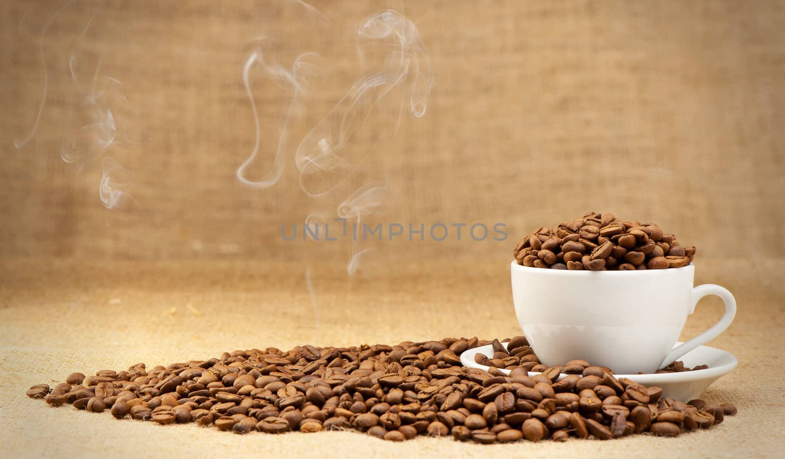 Cup with grains of coffee and a smoke. Grunge background