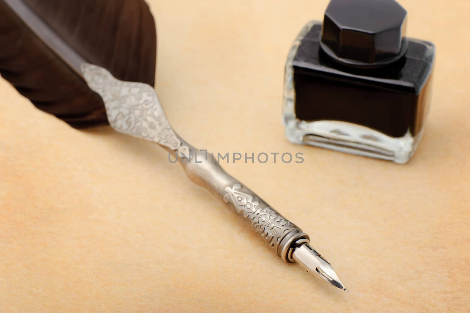 Feather quill and inkwell on an old paper by galdzer