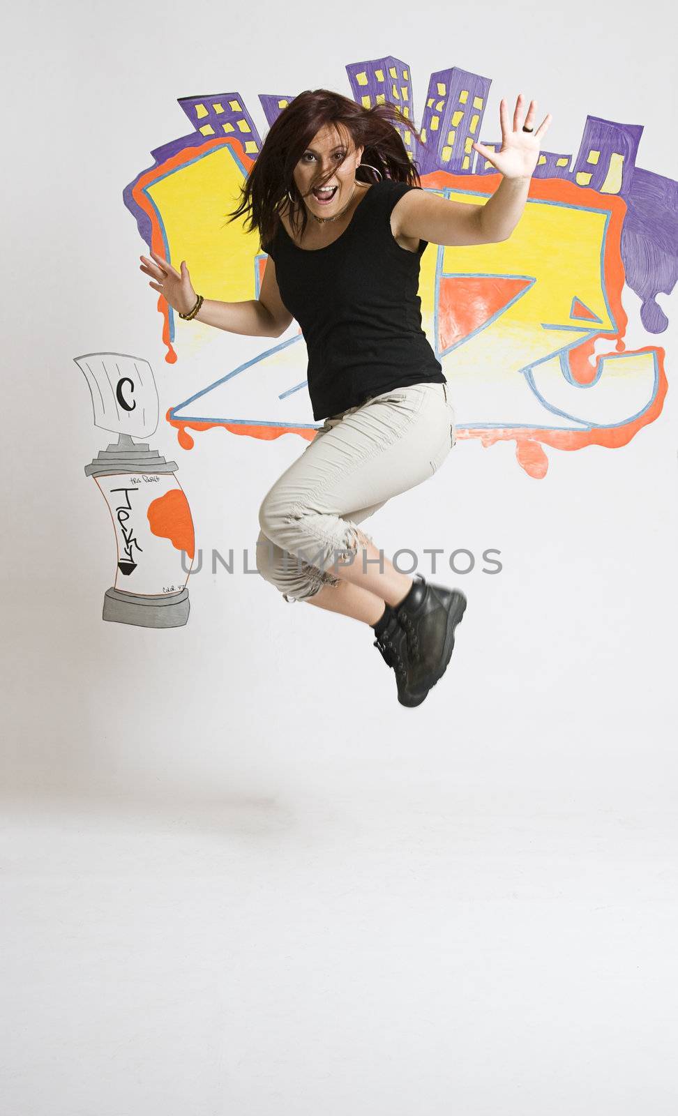 Late twenties break dancing girl in the middle of a jump