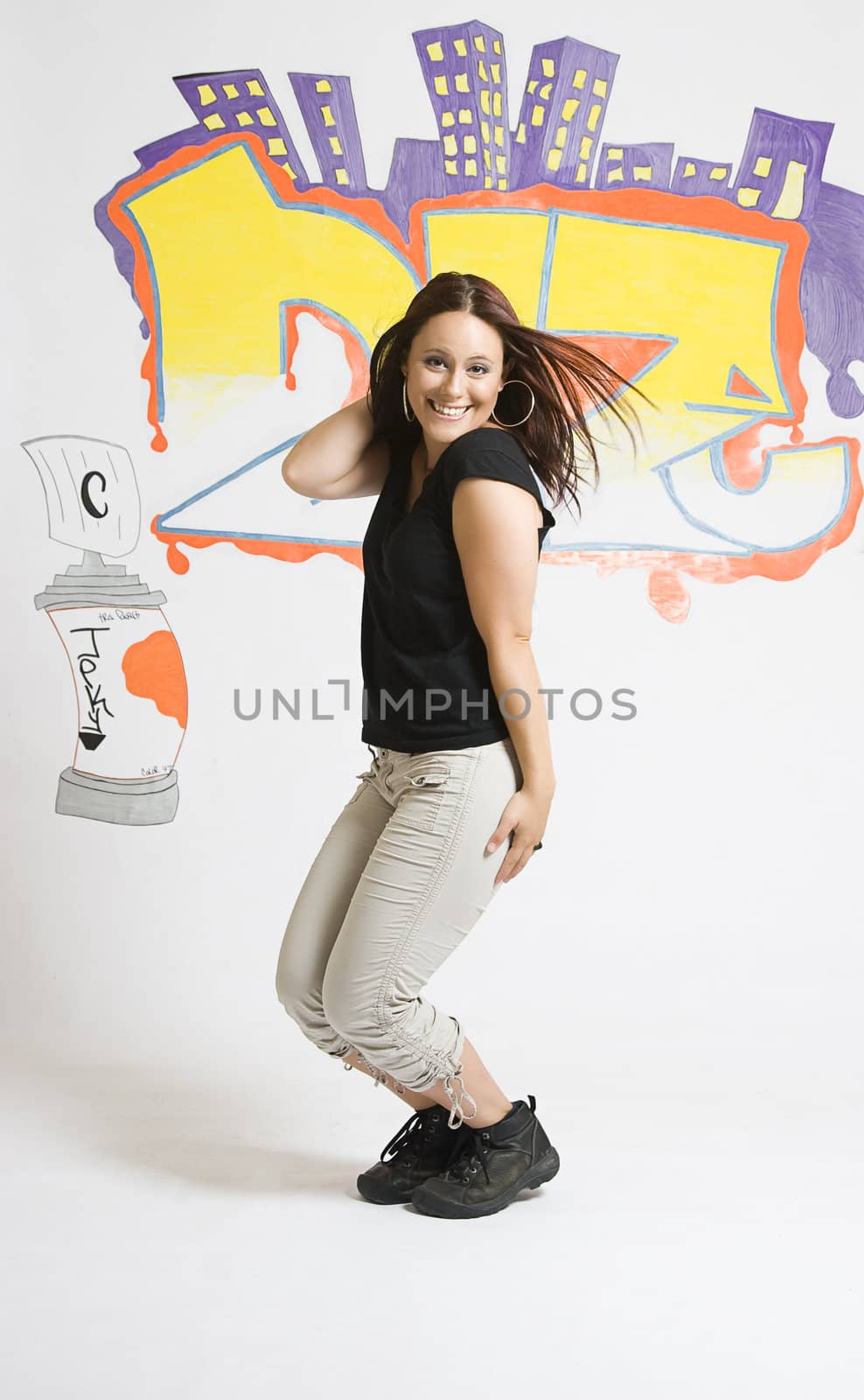 Late twenties break dancing girl in the middleof a cute pose