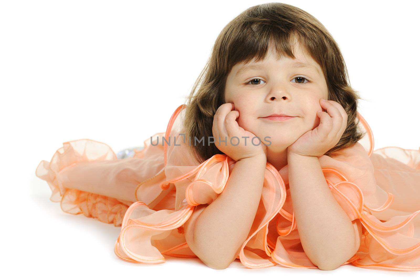 Pretty the little girl lies on the white. It is isolated on a white background