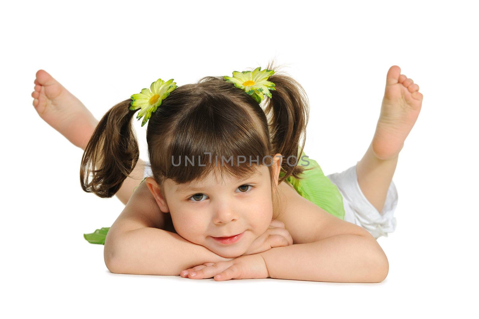 Pretty the little girl lies on the white. It is isolated on a white background