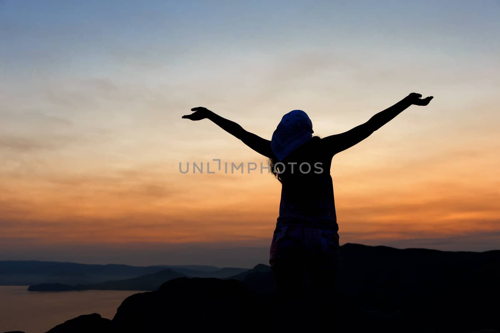 The woman on a mountain with open hands welcomes a decline
 by galdzer