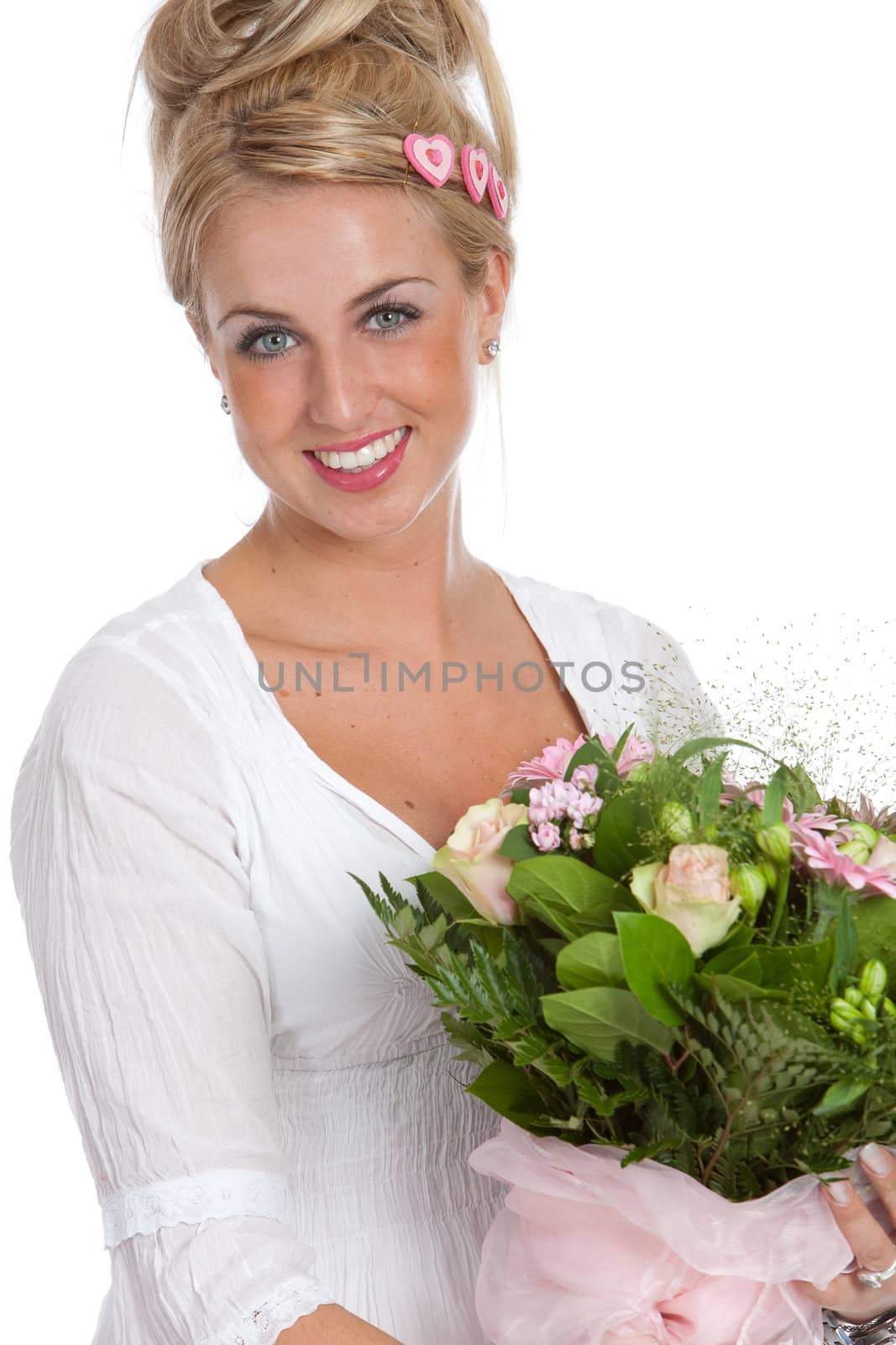 Beautiful young girl with a bunch of pink flowers smiling