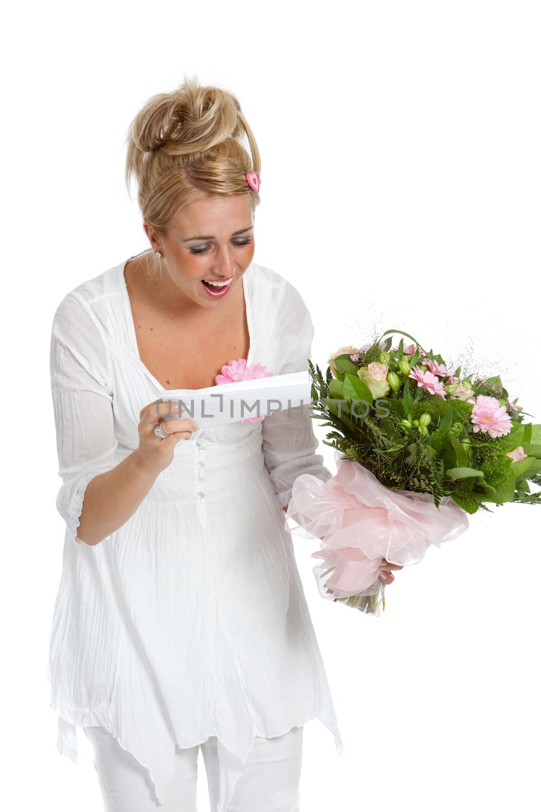 Beautiful girl looking happy and surprised at the note that came with the flowers
