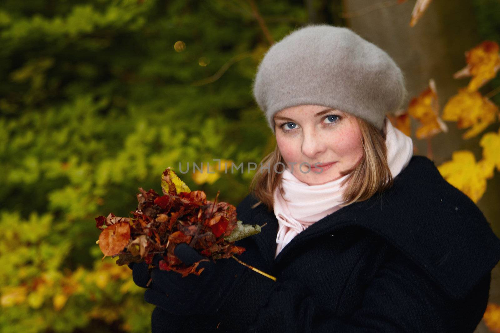 Fall - Cute young woman holding leaves