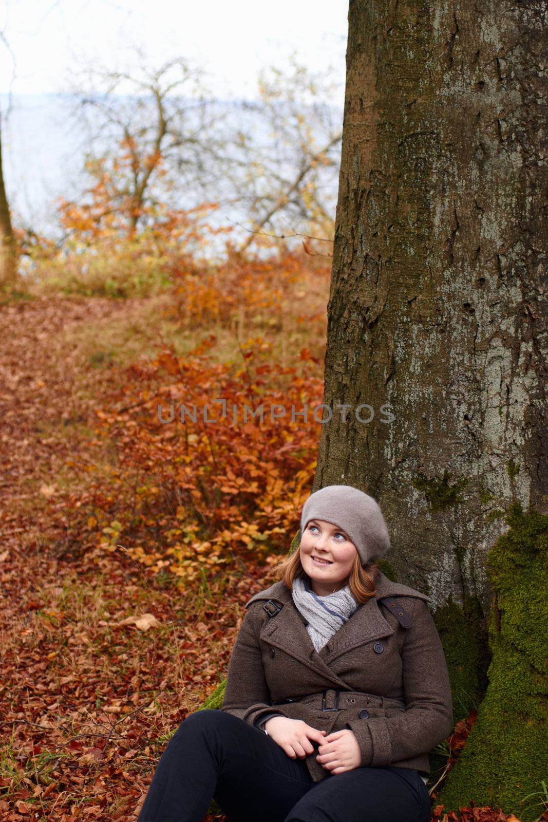 Fall - Cute young woman looking up at copy space