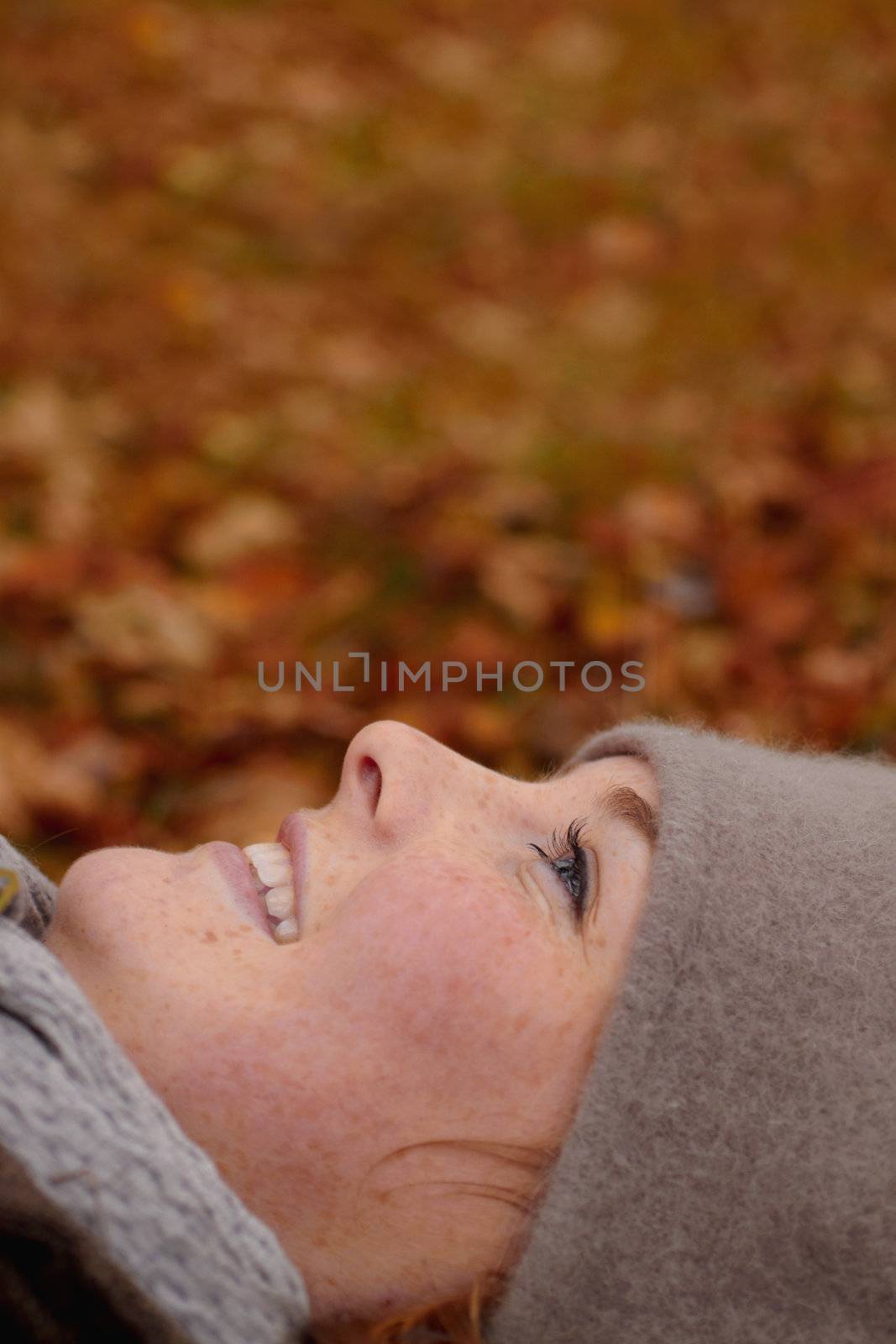 Fall - Beautiful young woman looking up at copy space