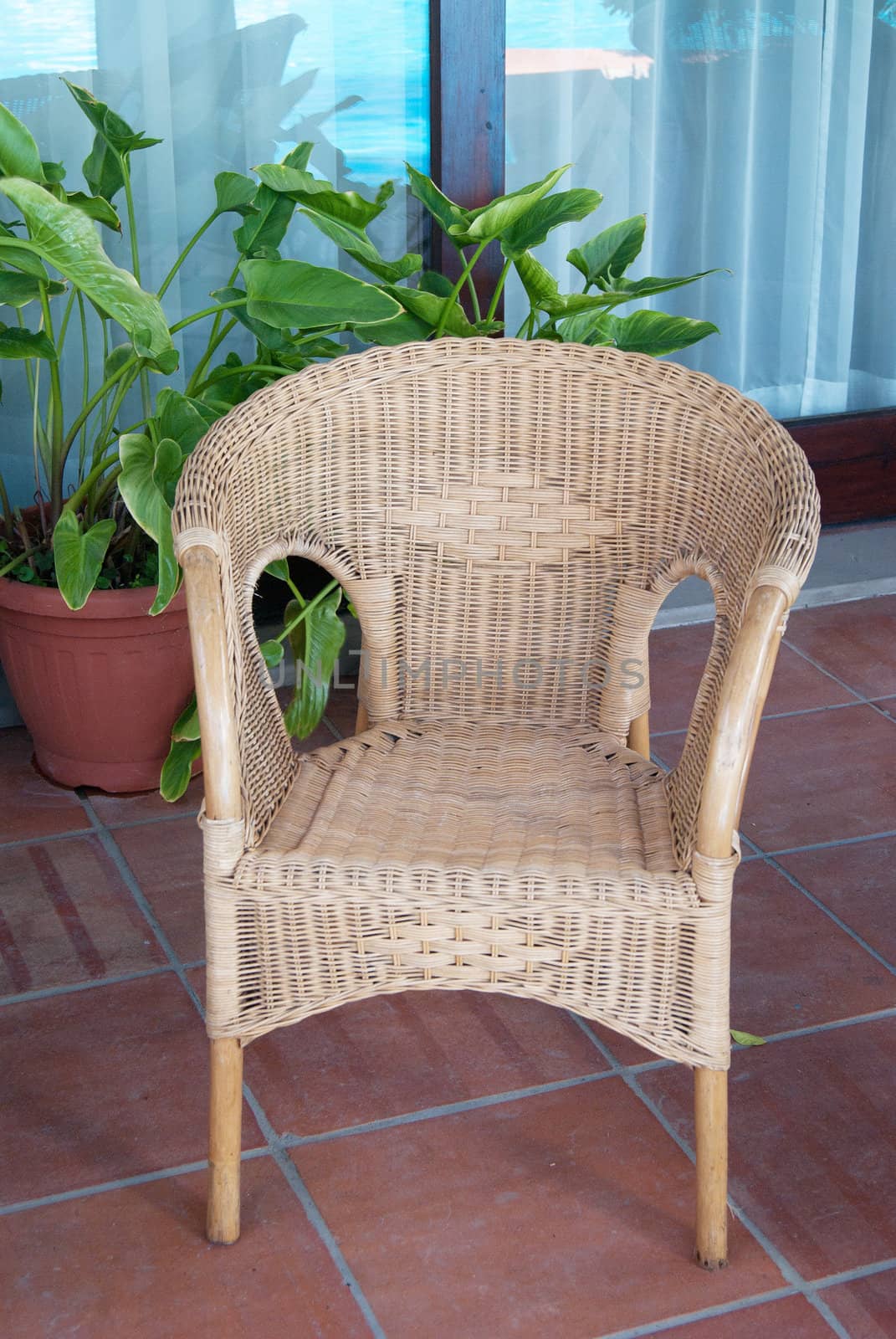 Wicker chair rattan brown villa near the  window on stone slabs vertical format