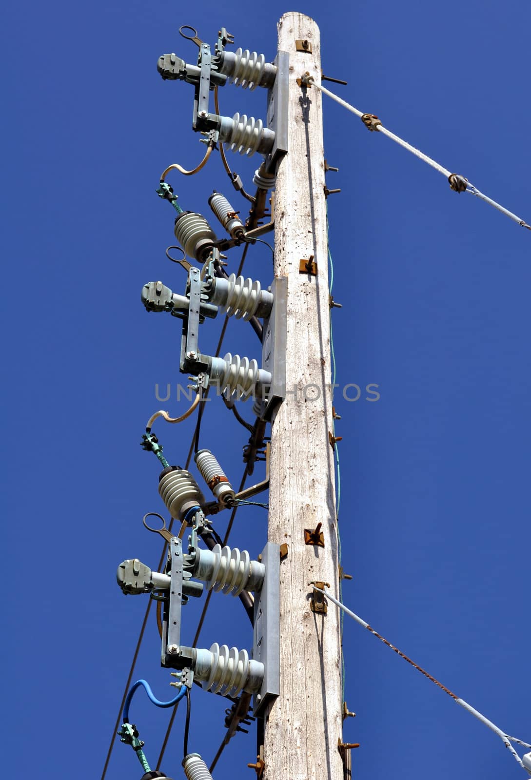 Electrical power pole with associated distribution lines and components.